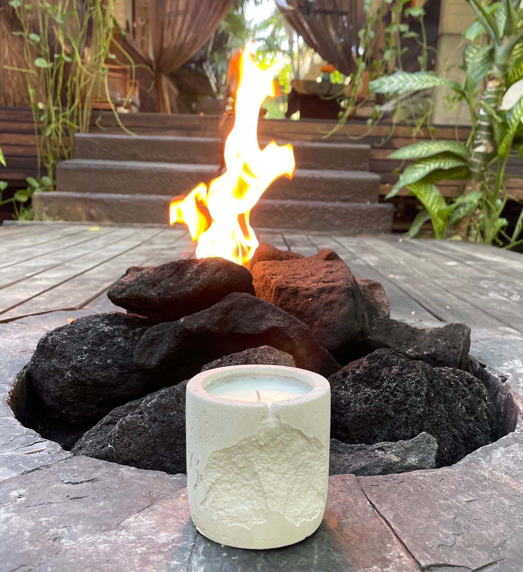 candle by firepit at dusk
